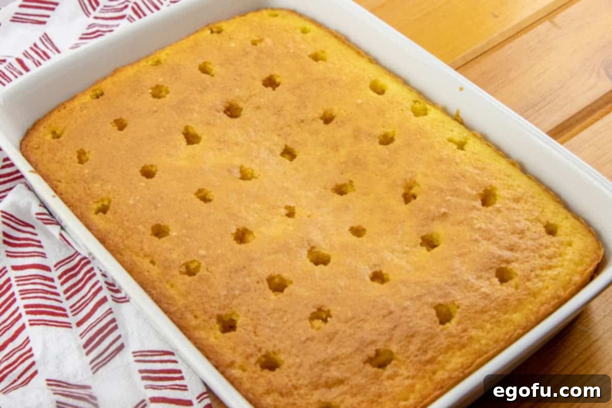 evenly spaced holes poked in fully baked lemon cake mix.