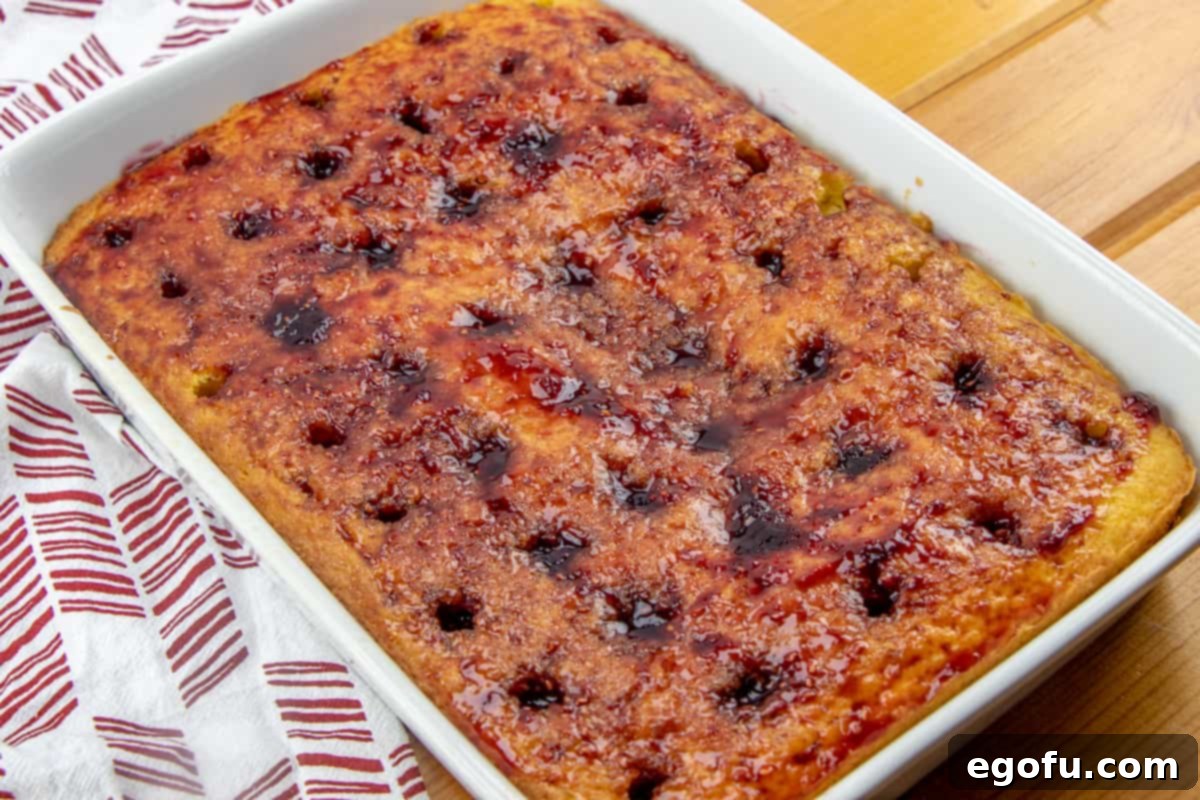 pouring raspberry preserves into lemon cake mix.
