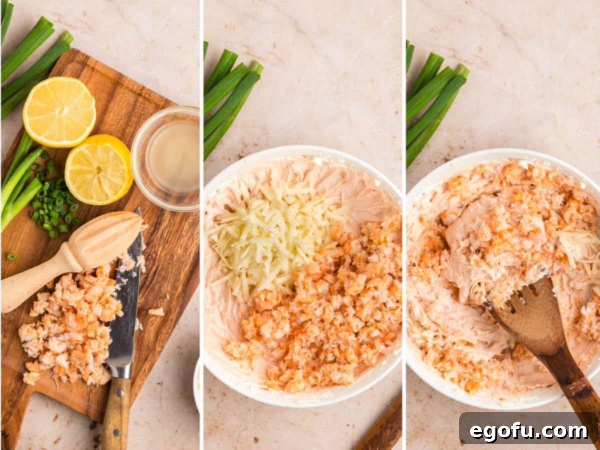 Finely chopped shrimp and shredded mozzarella cheese being stirred into the creamy dip mixture.