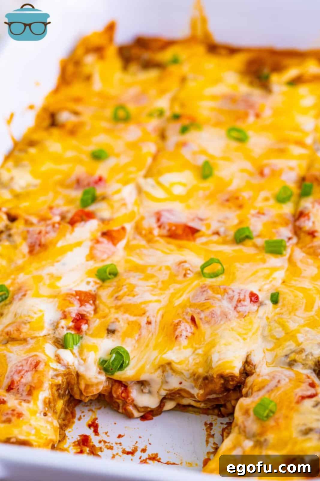 A delicious slice of Mexican Lasagna being removed from the baking dish with a spatula.