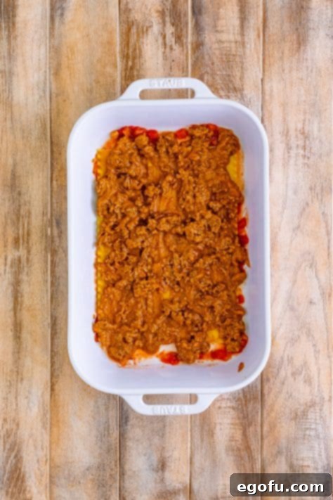 ground beef mixture layered on top of lasagna noodles.