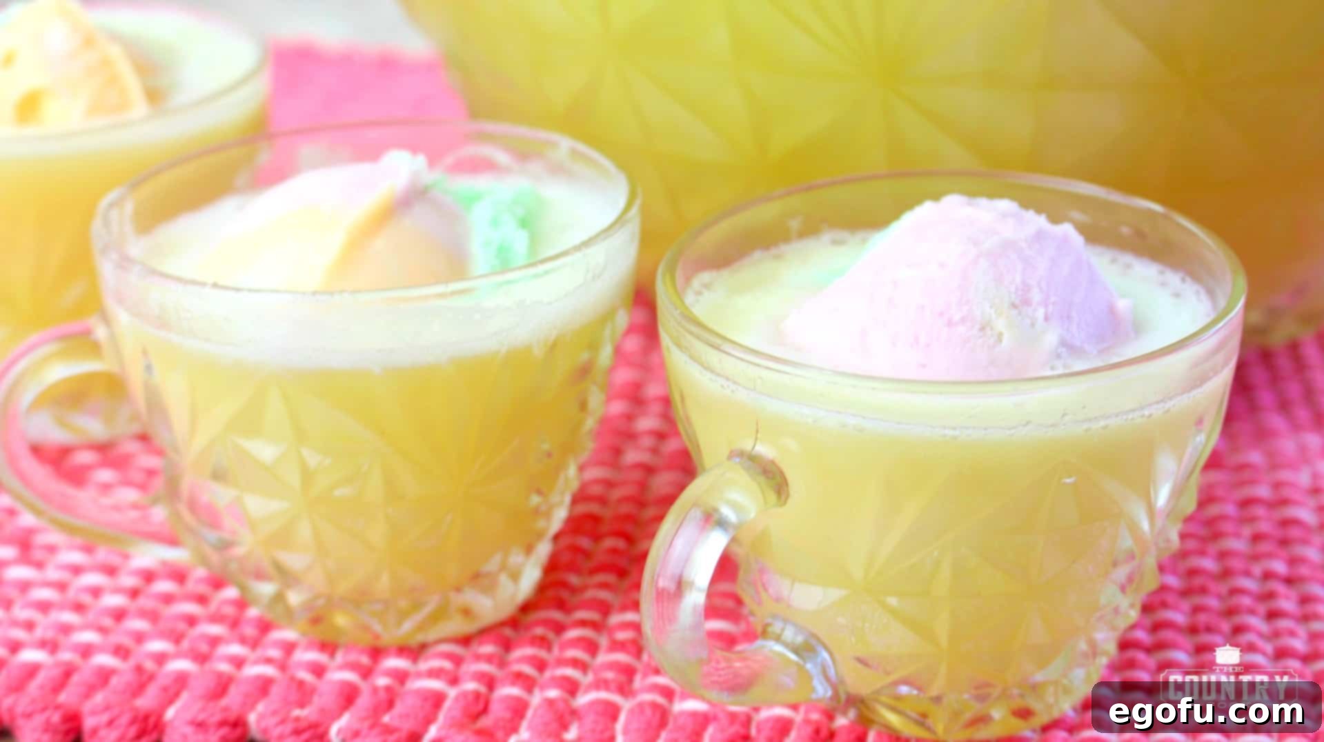 Close-up of Presbyterian Punch in glasses, highlighting the frothy texture and vibrant colors.