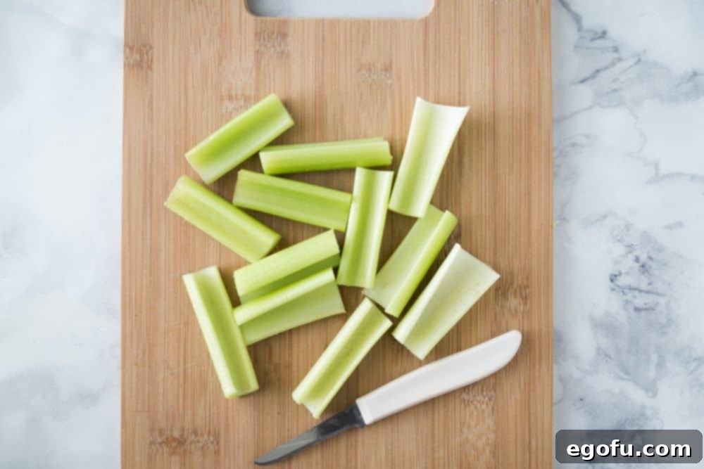 Chopped celery on a wood cutting board, prepared for stuffing.
