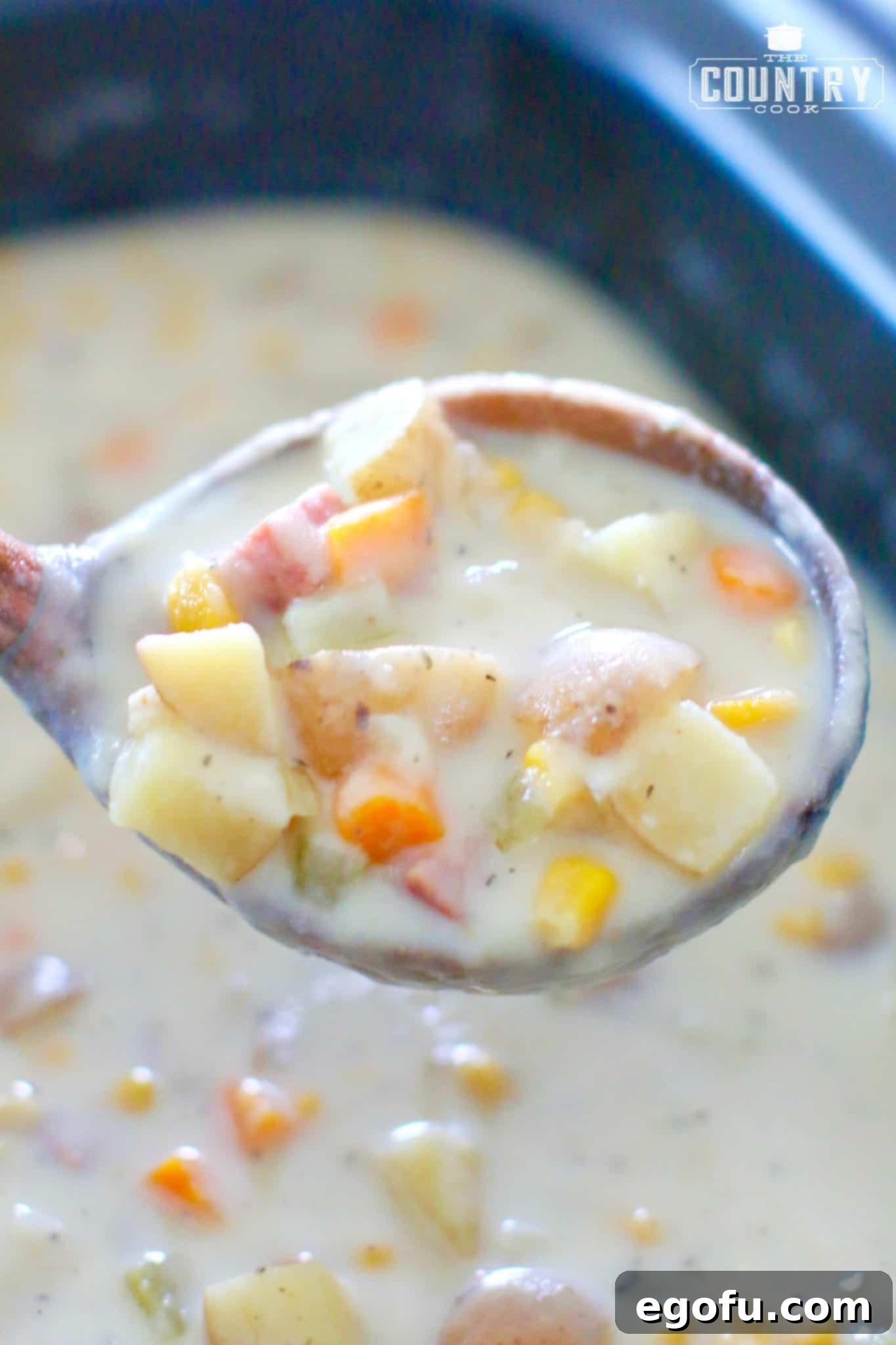 a wood ladle full of chowder.