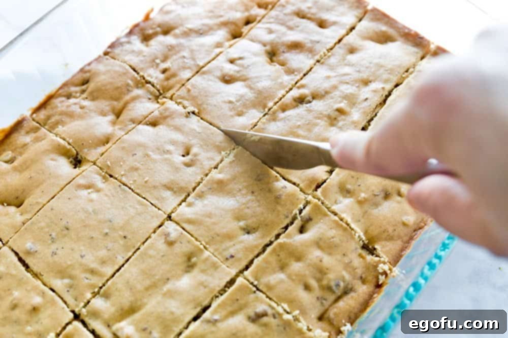 Homemade Applebees Blondies 7 Freshly baked and sliced blondies with walnuts visible, arranged on a cooling rack.