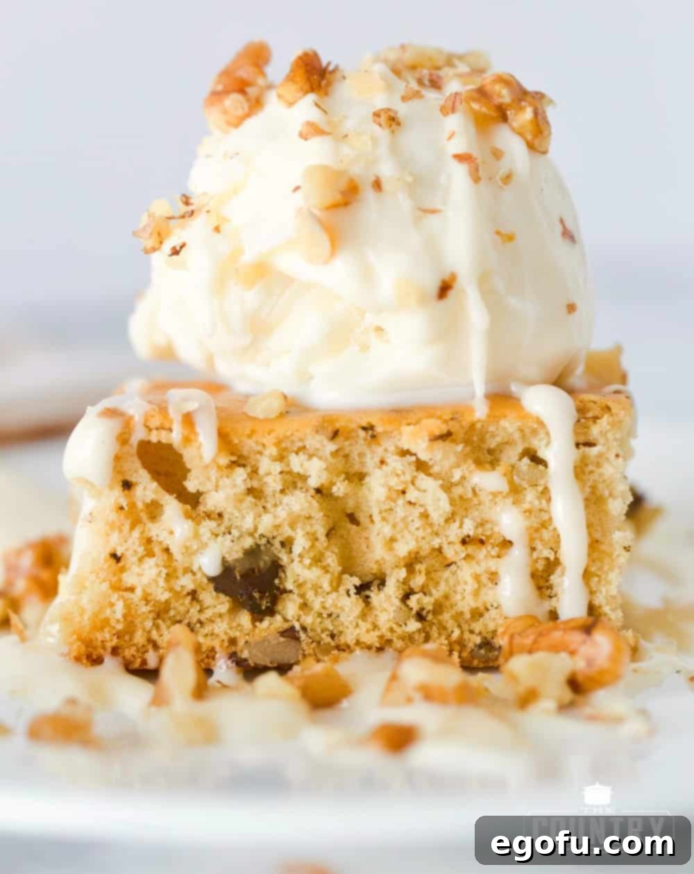 Homemade Applebees Blondies 8 Close-up of a White Blondie with a large scoop of vanilla ice cream and an abundant drizzle of Maple Butter Cream Sauce.