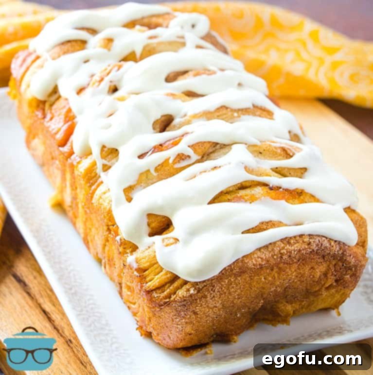 Finished Pumpkin Pull-Apart Bread with cream cheese icing drizzled on top, ready to serve