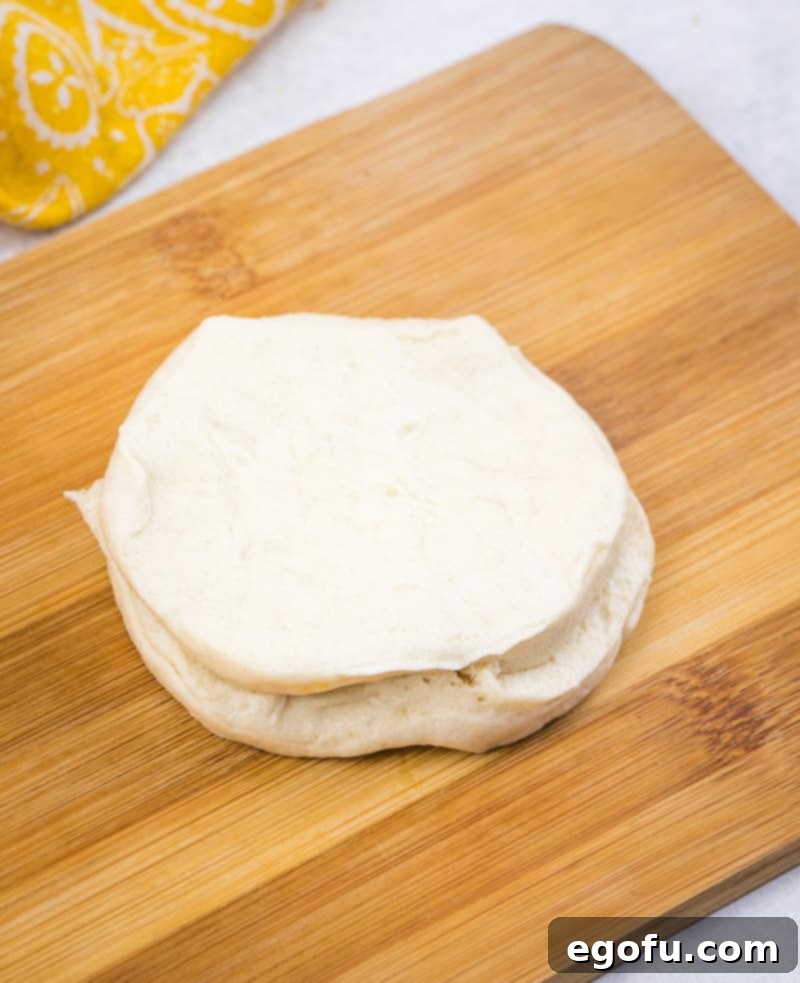 Layered biscuits being cut in half lengthwise before coating