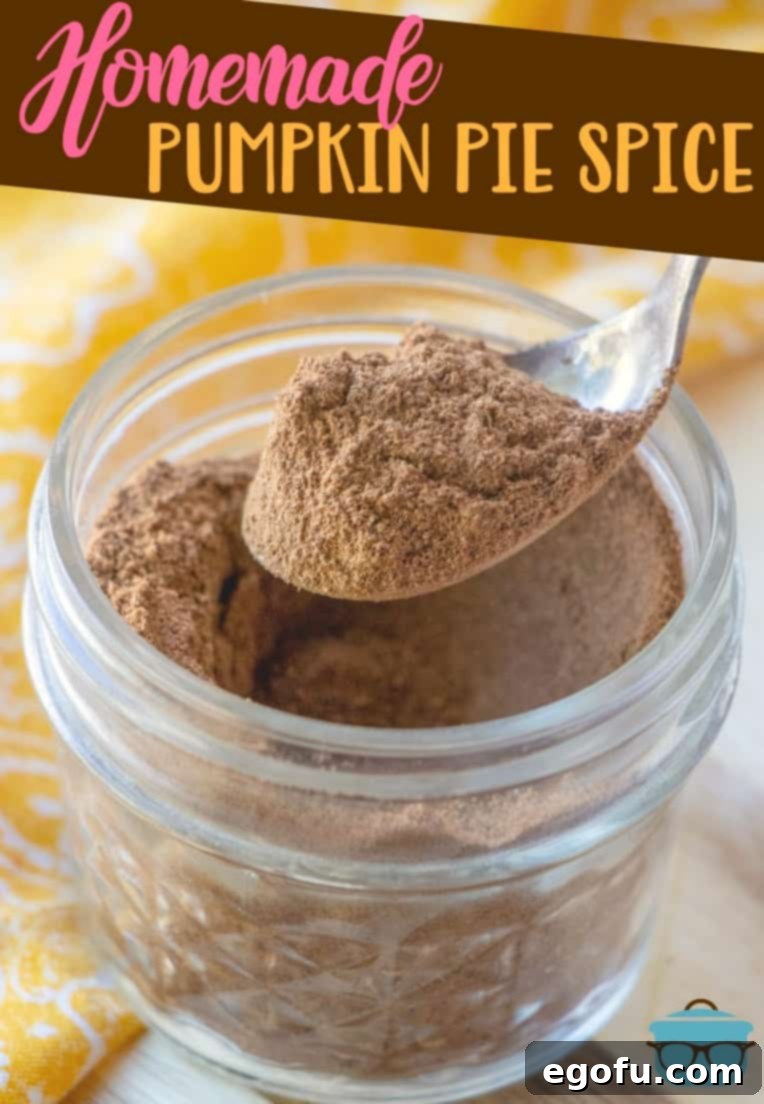 Homemade Pumpkin Pie Spice recipe from The Country Cook. A spoon holding the spice over a clear mason jar.