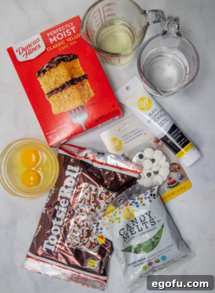 A collection of ingredients including cake mix, eggs, water, vegetable oil, green candy melts, black ready-to-use icing, candy eyeballs, and Tootsie Rolls, laid out for making Frankenstein Donuts.