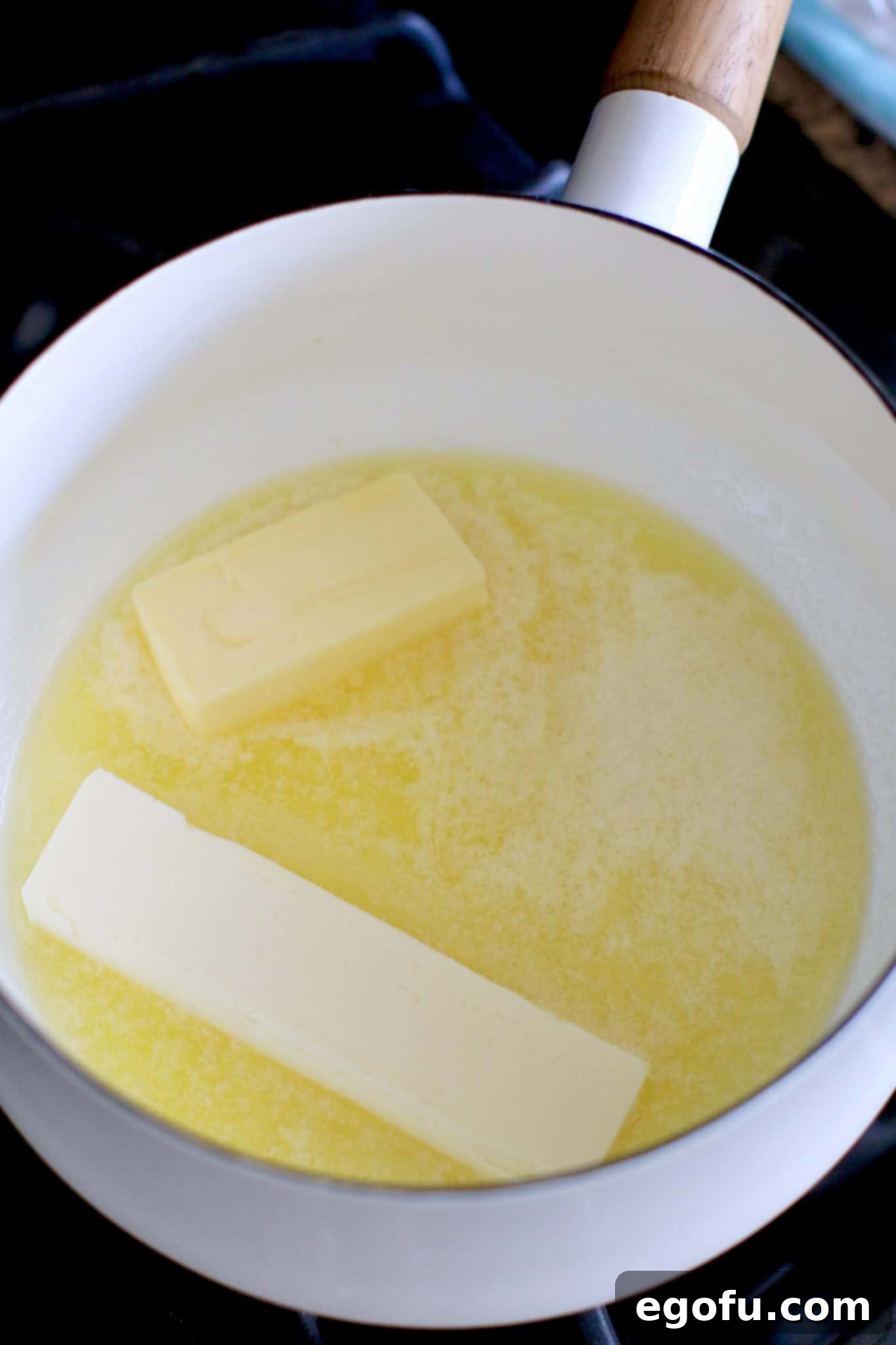 melting butter in a white sauce pot.