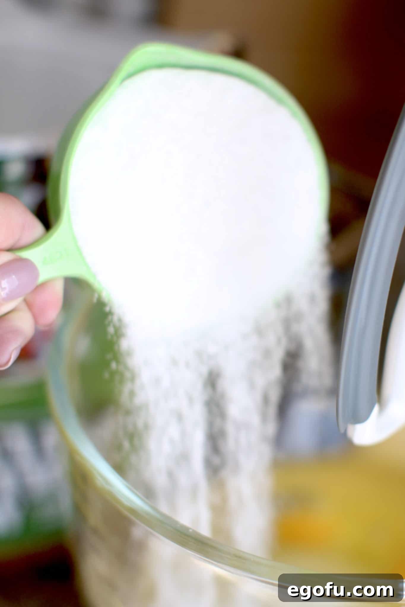 pouring Stevia in the raw into batter bowl.