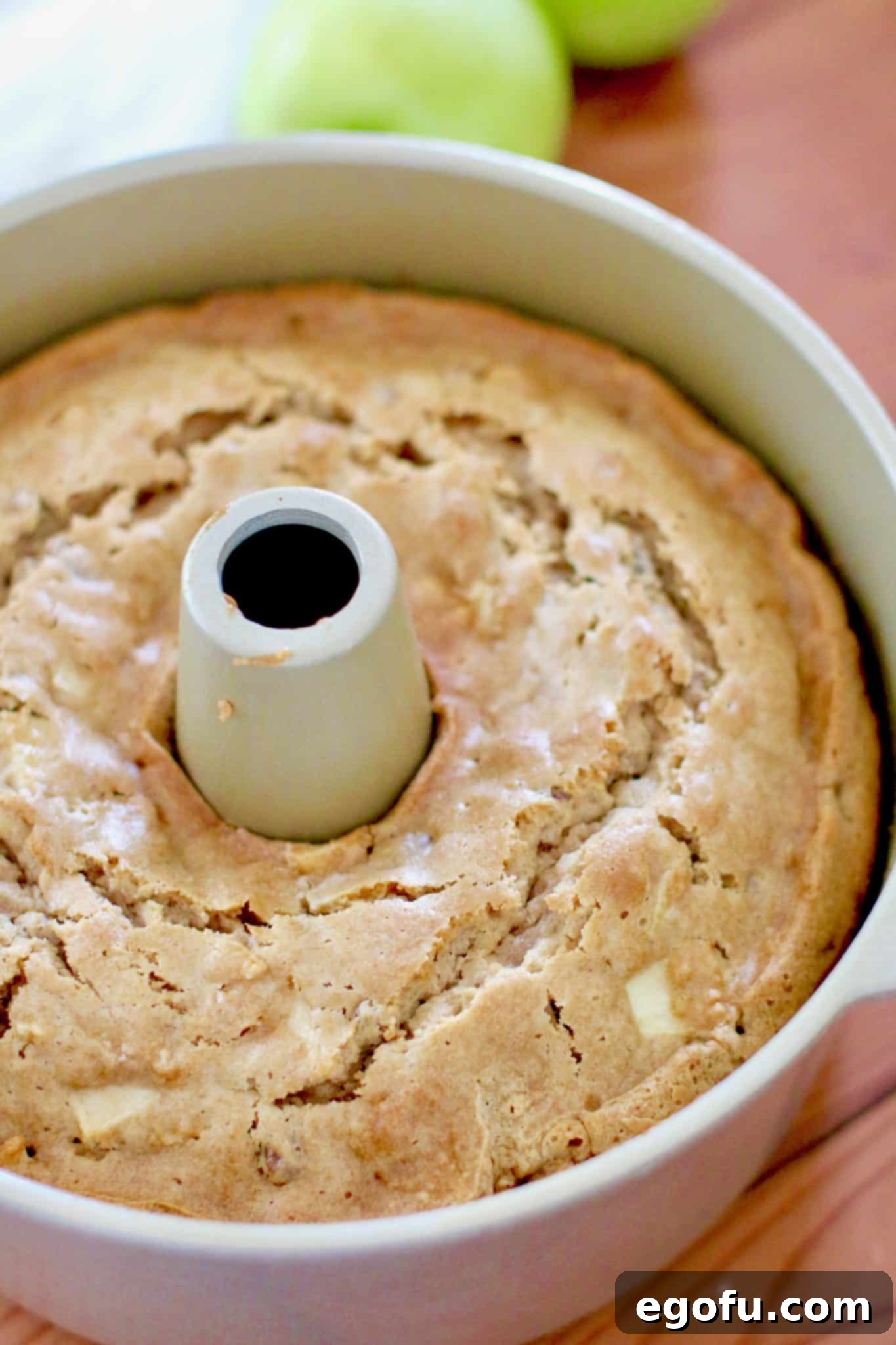 caramel apple cake cooling in a bundt pan after being baked.