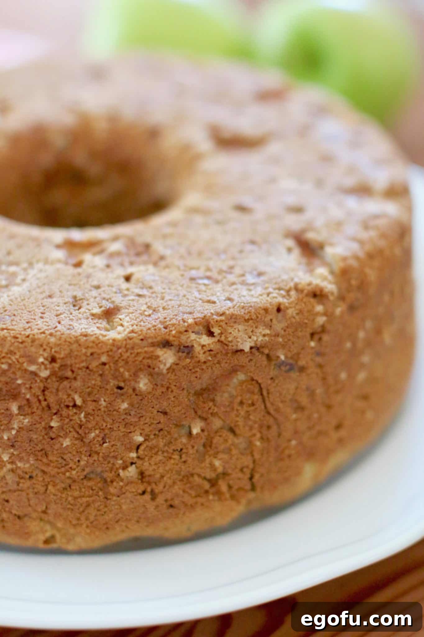 caramel apple cake fully baked and turned out onto a white platter. 