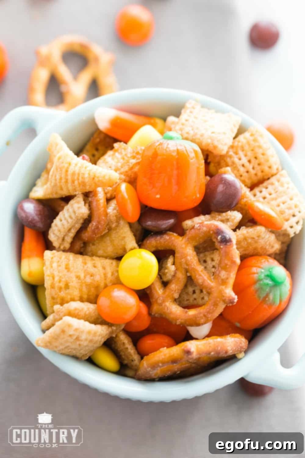 Small white bowl filled with sweet chex mix, ready to be served or stored.