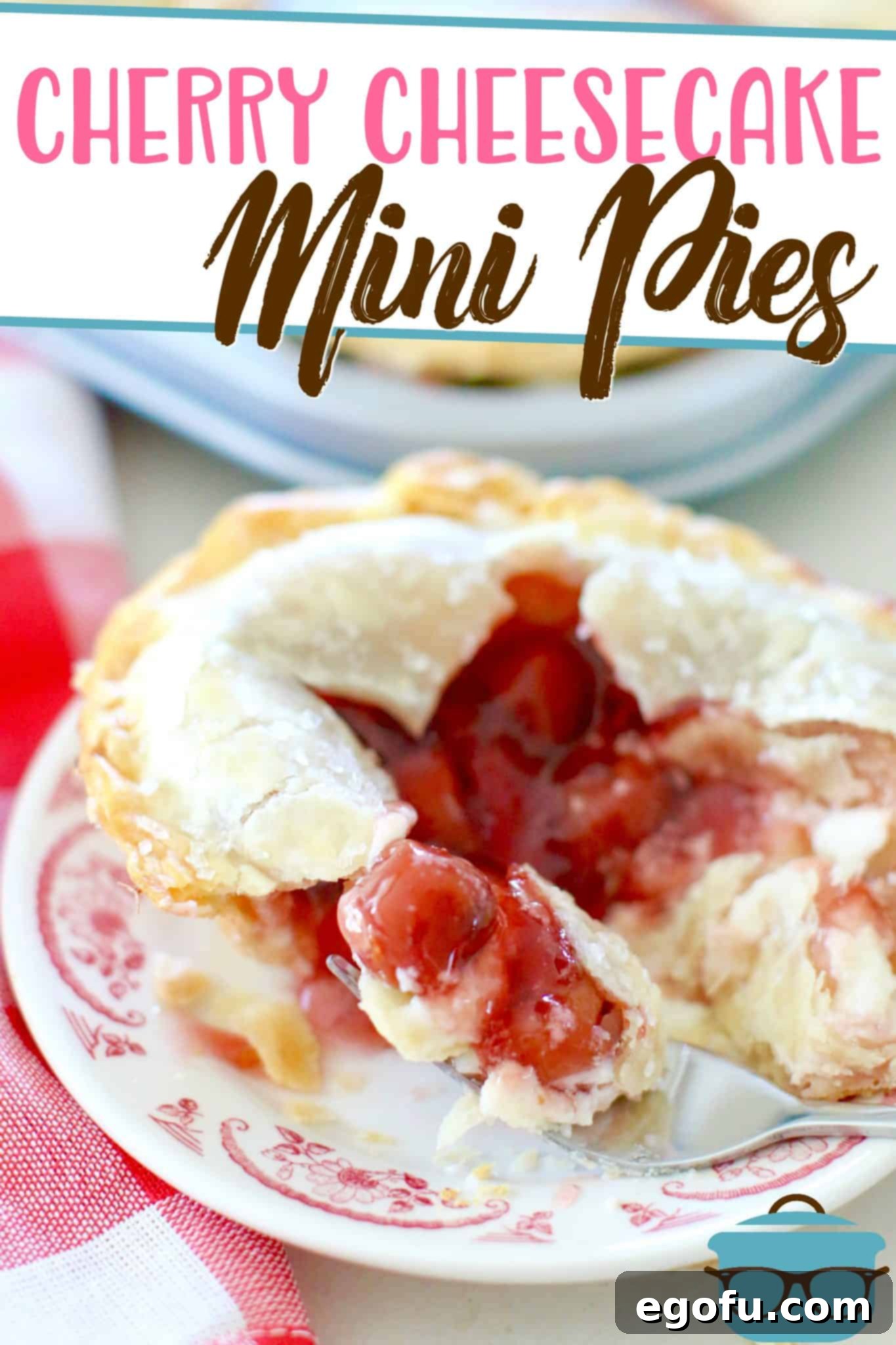 Cherry Cheesecake Minis 3 Close-up of a Mini Cherry Cheesecake Pie, sliced open to reveal the distinct layers of flaky crust, creamy cheesecake, and vibrant cherry filling.