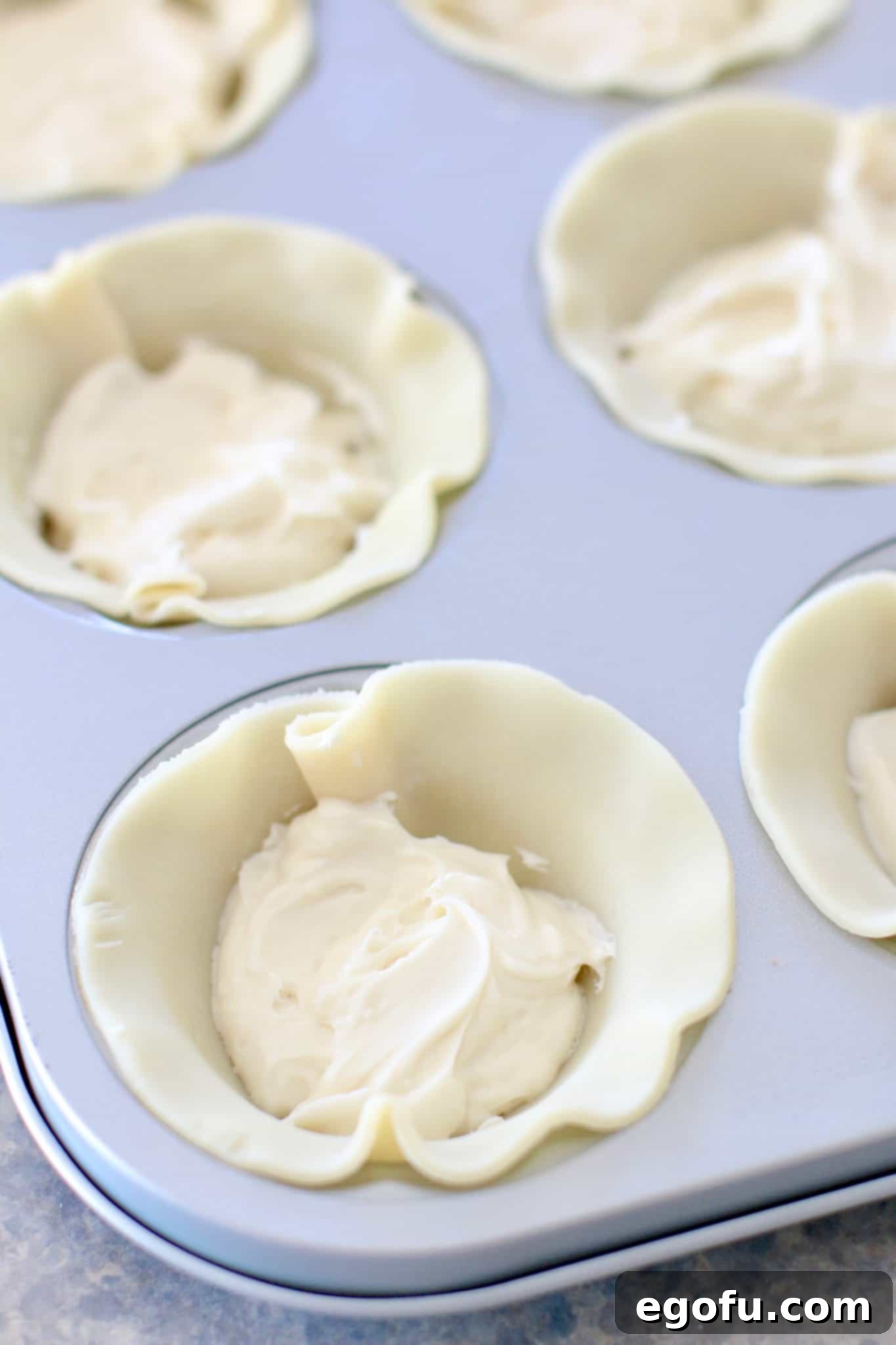 Cherry Cheesecake Minis 9 Creamy cheesecake filling meticulously spooned into the base of each pie crust in the mini pie pan.