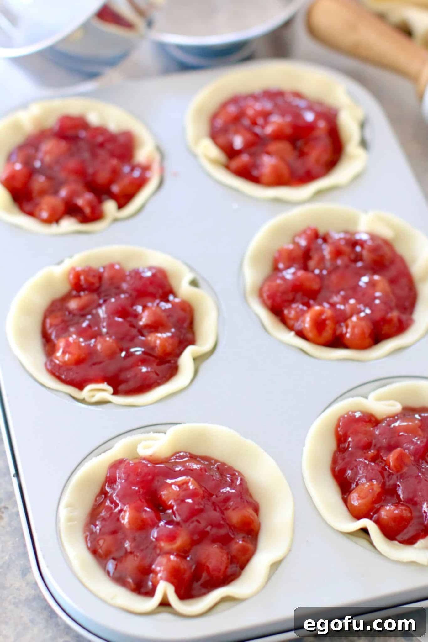 Cherry Cheesecake Minis 10 Sweet cherry pie filling generously layered on top of the creamy cheesecake mixture within the mini pie pan wells.