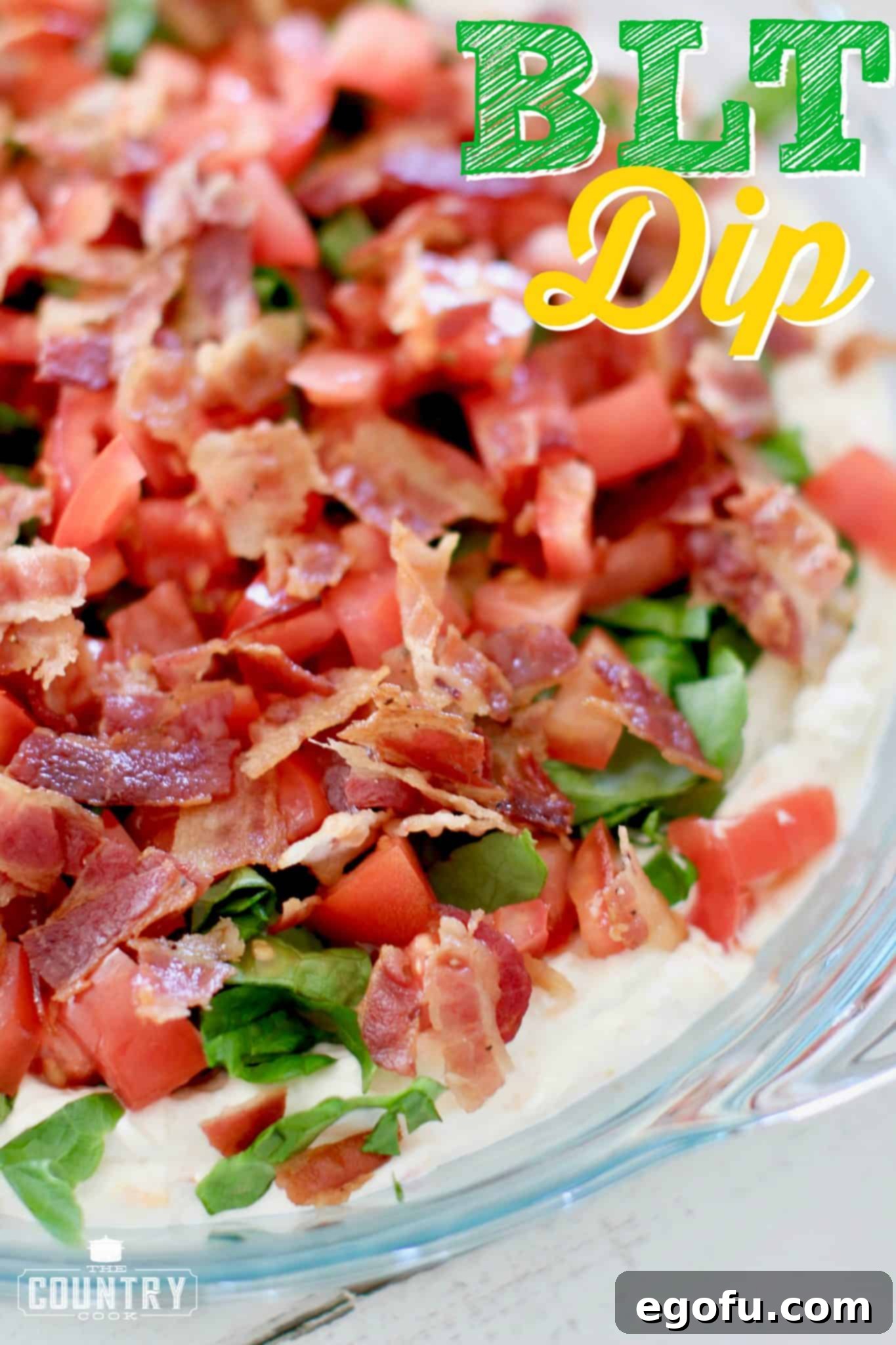 closeup photo of the BLT Dip in a clear pie plate. 