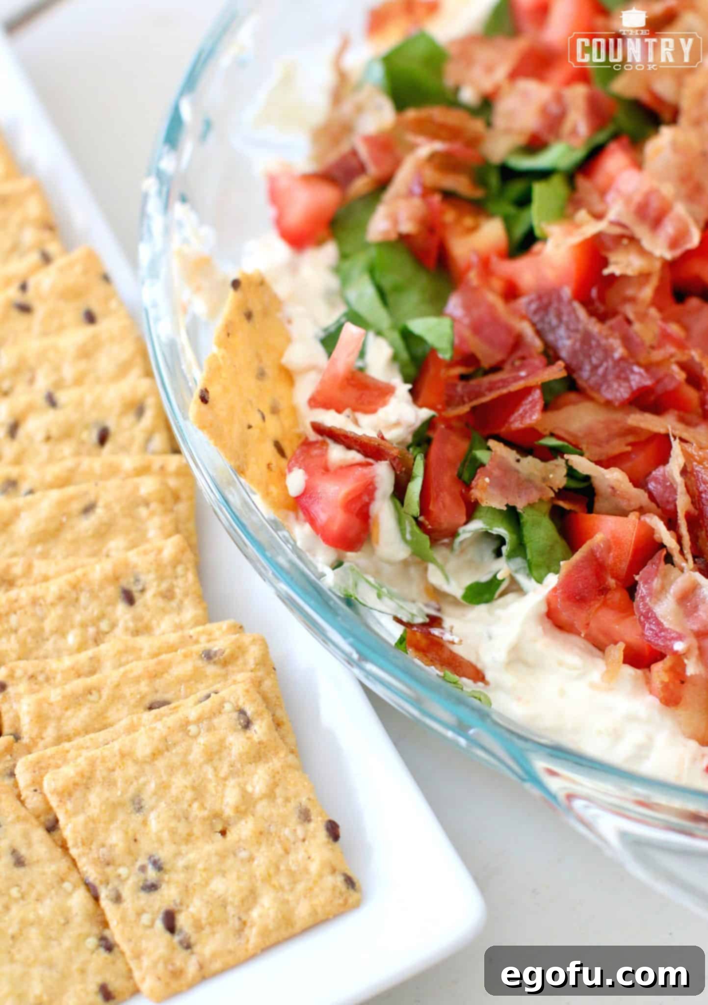 a cracker shown pressed into the BLT dip.