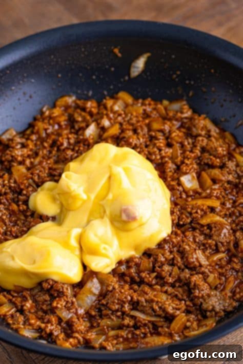 Cream of chicken soup sitting on beef and onion.