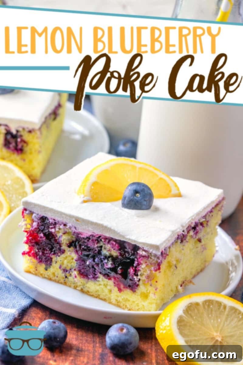 Lemon Blueberry Poke Cake recipe from The Country Cook, pictured, slice on a plate, topped with a fresh lemon slice and a blueberry.