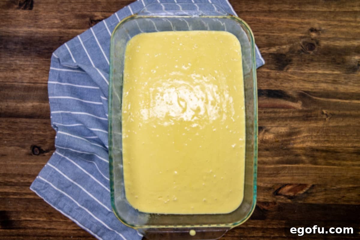 prepared lemon cake mix batter in a clear glass o-inch by 13-inch baking dish.