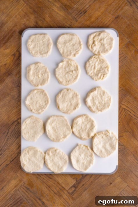 Refrigerated biscuit slices laid out on a cutting board.