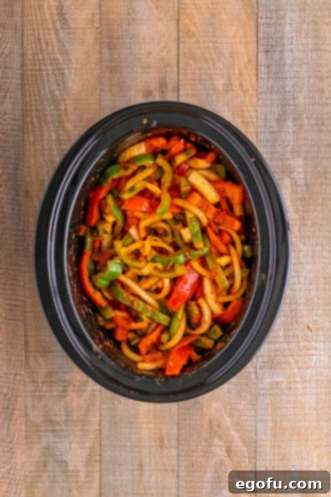 Cooked sausage and oninos in a slow cooker.