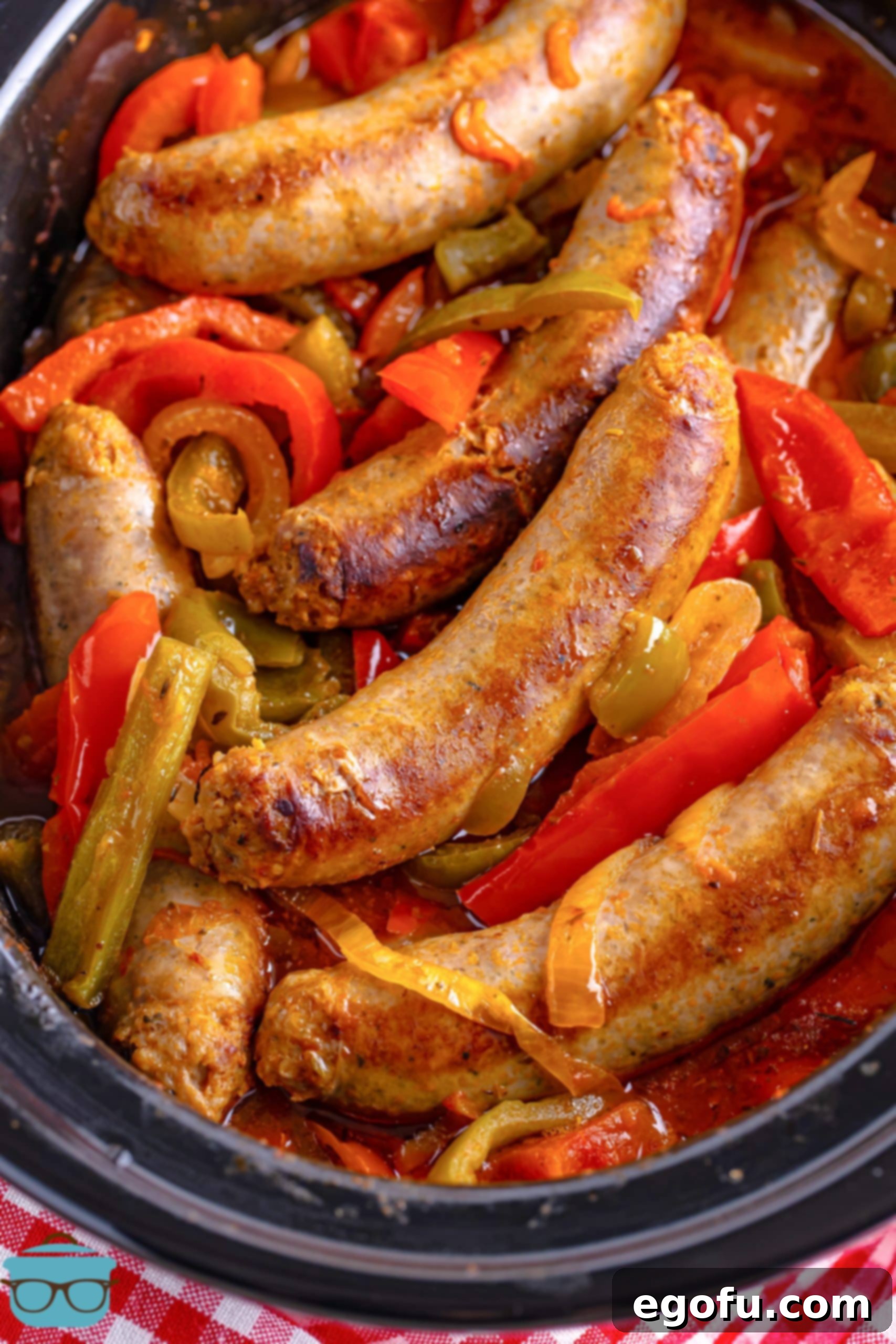 Close up looking at Sausage and Peppers in a slow cooker.