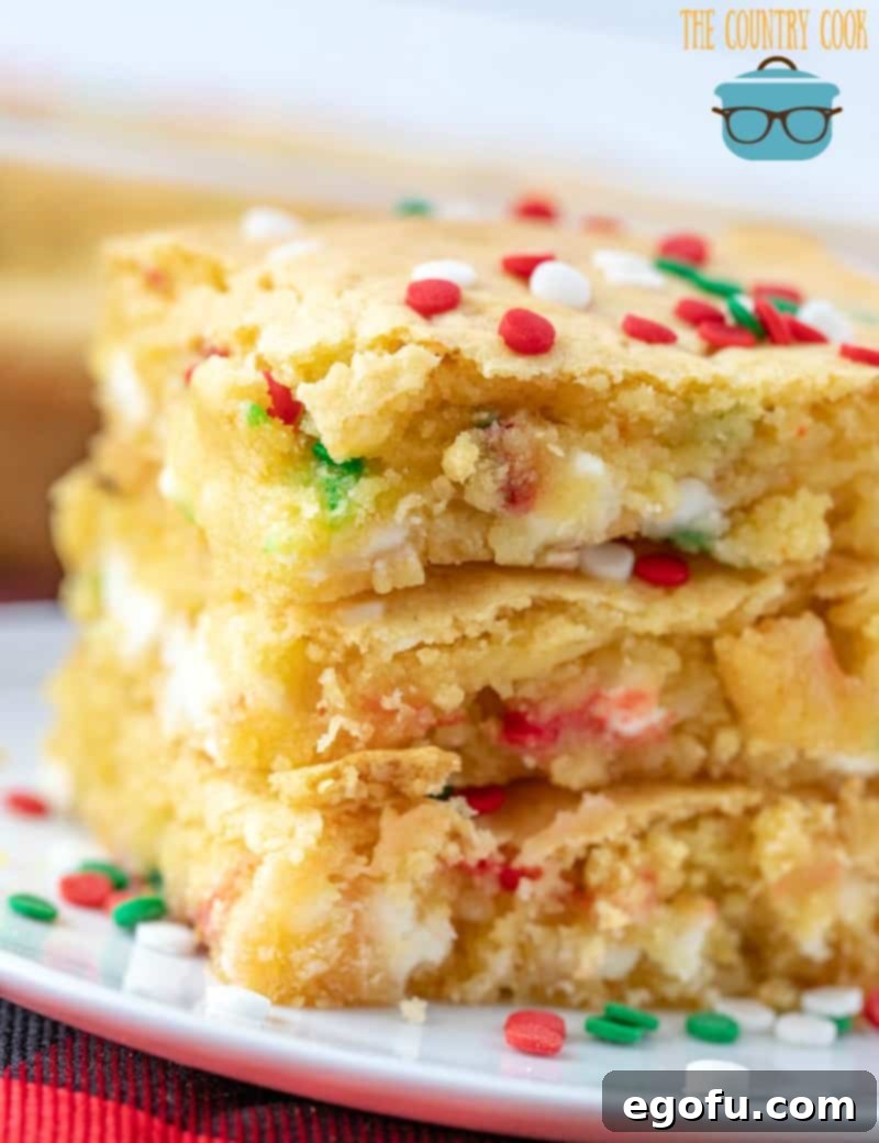 Stacked Easy Holiday Blondie Bars with white chocolate, ready to be served.