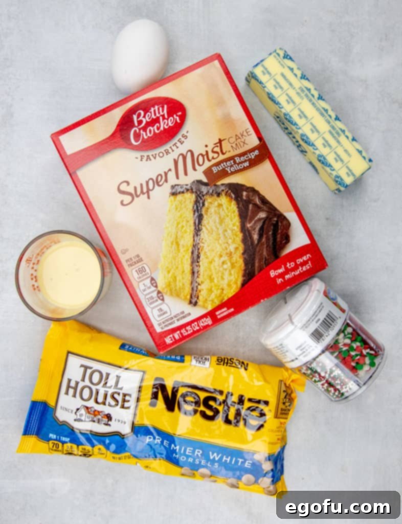 Ingredients for Holiday Blondie Bars: cake mix, eggnog, butter, egg, white chocolate chips, sprinkles.