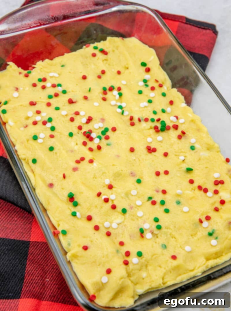 Red, white, and green sprinkles added on top of the final layer of cake batter.