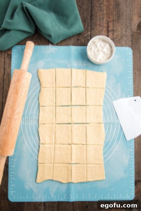 Golden Cranberry Brie Delights 11 24 squares cut into crescent roll dough.