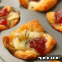 Golden Cranberry Brie Delights 9 Cranberry Brie Bites fully baked in a muffin tin.
