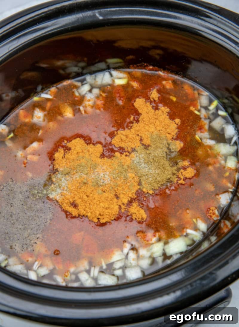 chicken breast, salsa, taco seasoning, diced onion in a 6-quart slow cooker.