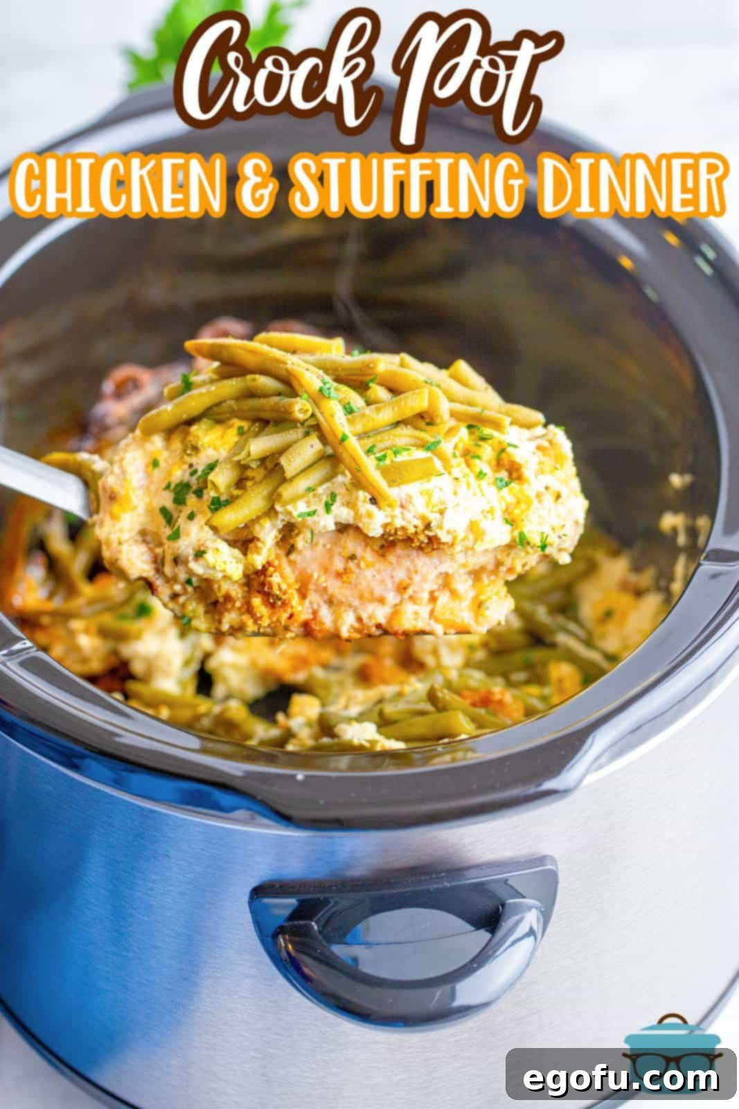 a spoon holding up a serving of chicken and stuffing over a slow cooker. 