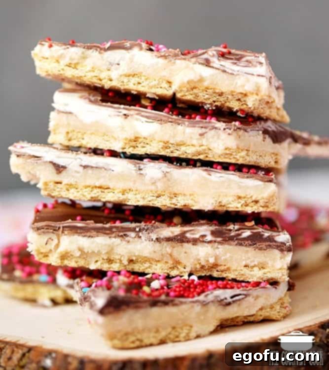 Marbled Valentine's Day No Bake Graham Cracker Toffee shown stacked on a white plate.