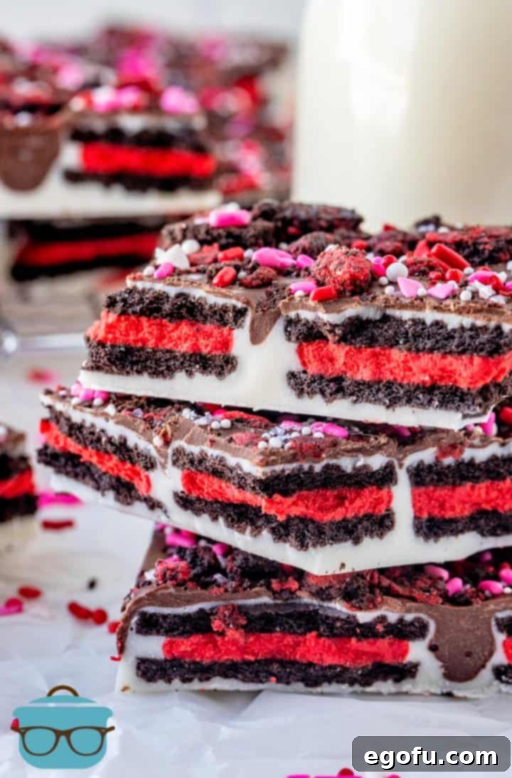 Cupids Oreo Bark 2 stacked pieces of oreo cookie bark with a bottle of milk in the background.