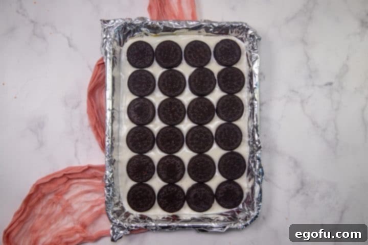 Cupids Oreo Bark 7 oreo cookies laid out in a single layer on top of melted white chocolate.