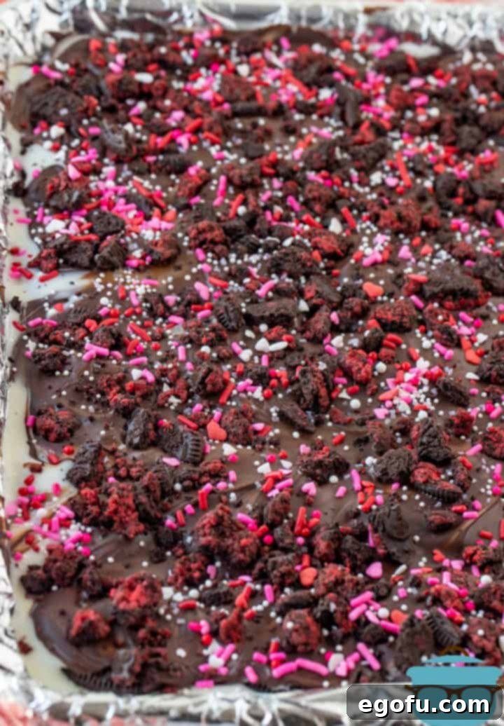 Cupids Oreo Bark 10 VALENTINE'S DAY OREO BARK cooling on a baking tray lined with aluminum foil.