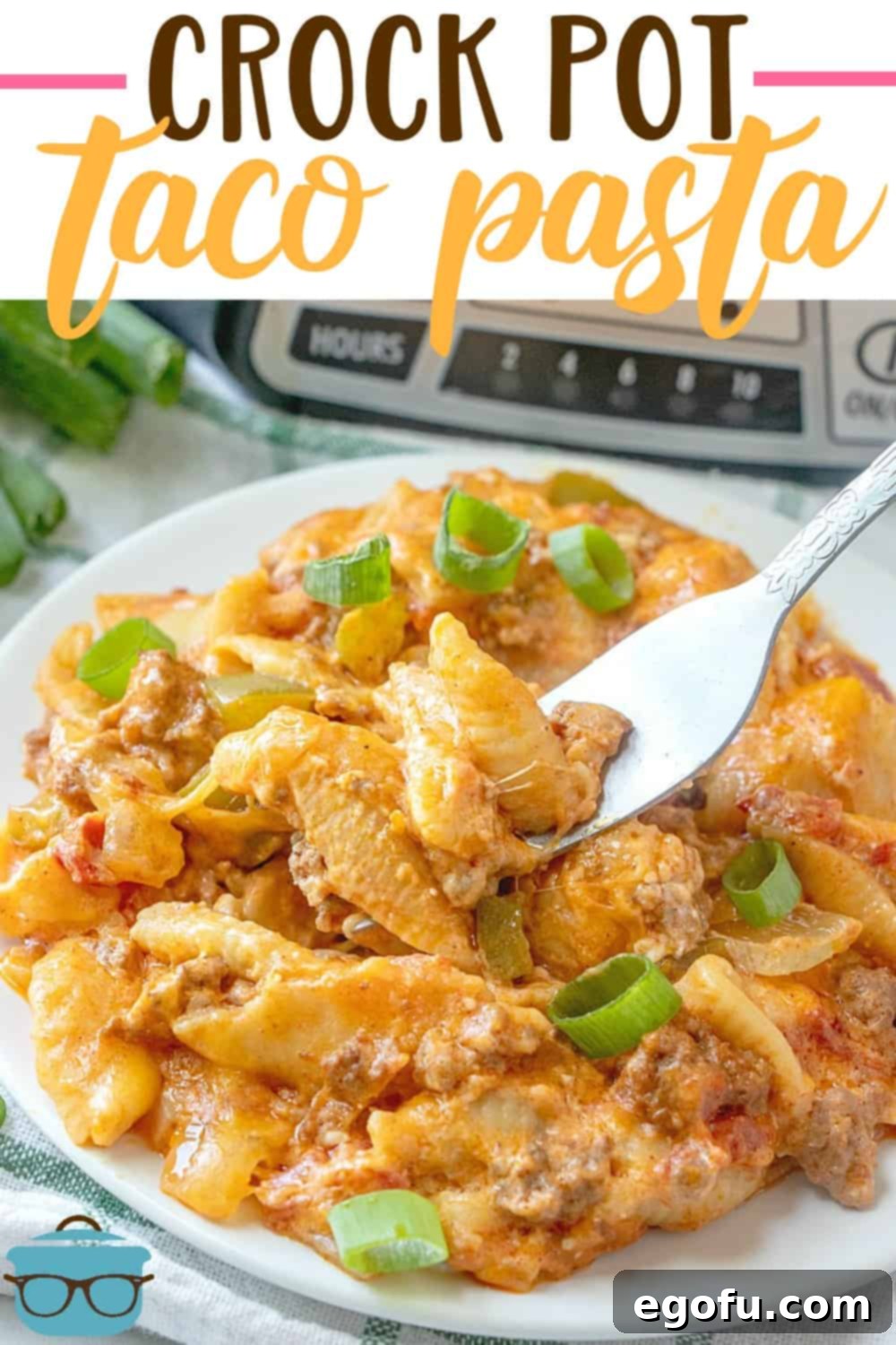 Easy Crock Pot Taco Pasta recipe shown on a round white plate with a fork.