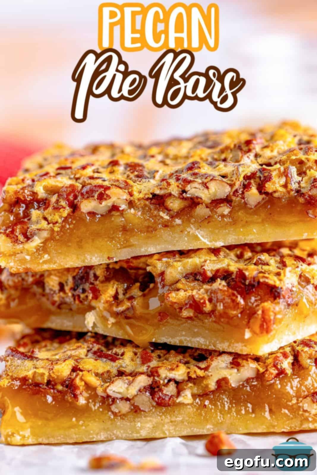 A close-up side view of three Southern Pecan Pie Bars stacked, clearly showing the distinct layers of the golden shortbread crust and the thick, rich pecan filling with whole and chopped nuts.