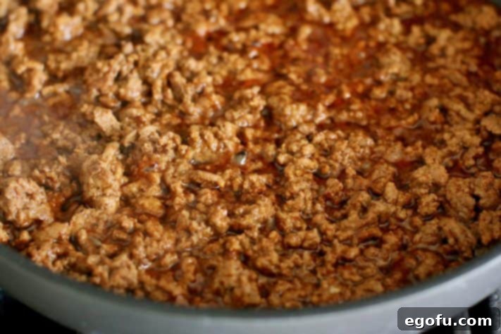 Fiesta Mac and Cheese 11 taco ground beef in skillet.