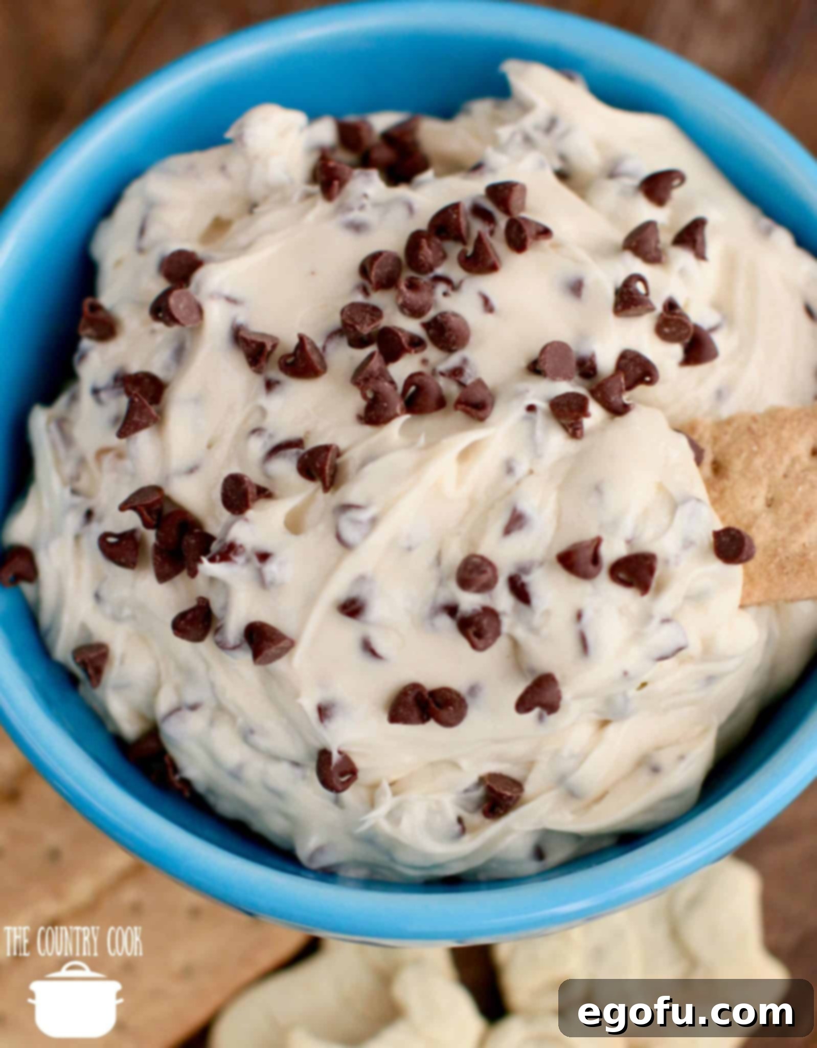 Decadent Chocolate Chip Dough Dip 2 Delicious Chocolate Chip Cookie Dough Dip recipe served in a blue bowl with honey graham crackers and animal crackers ready for dipping.
