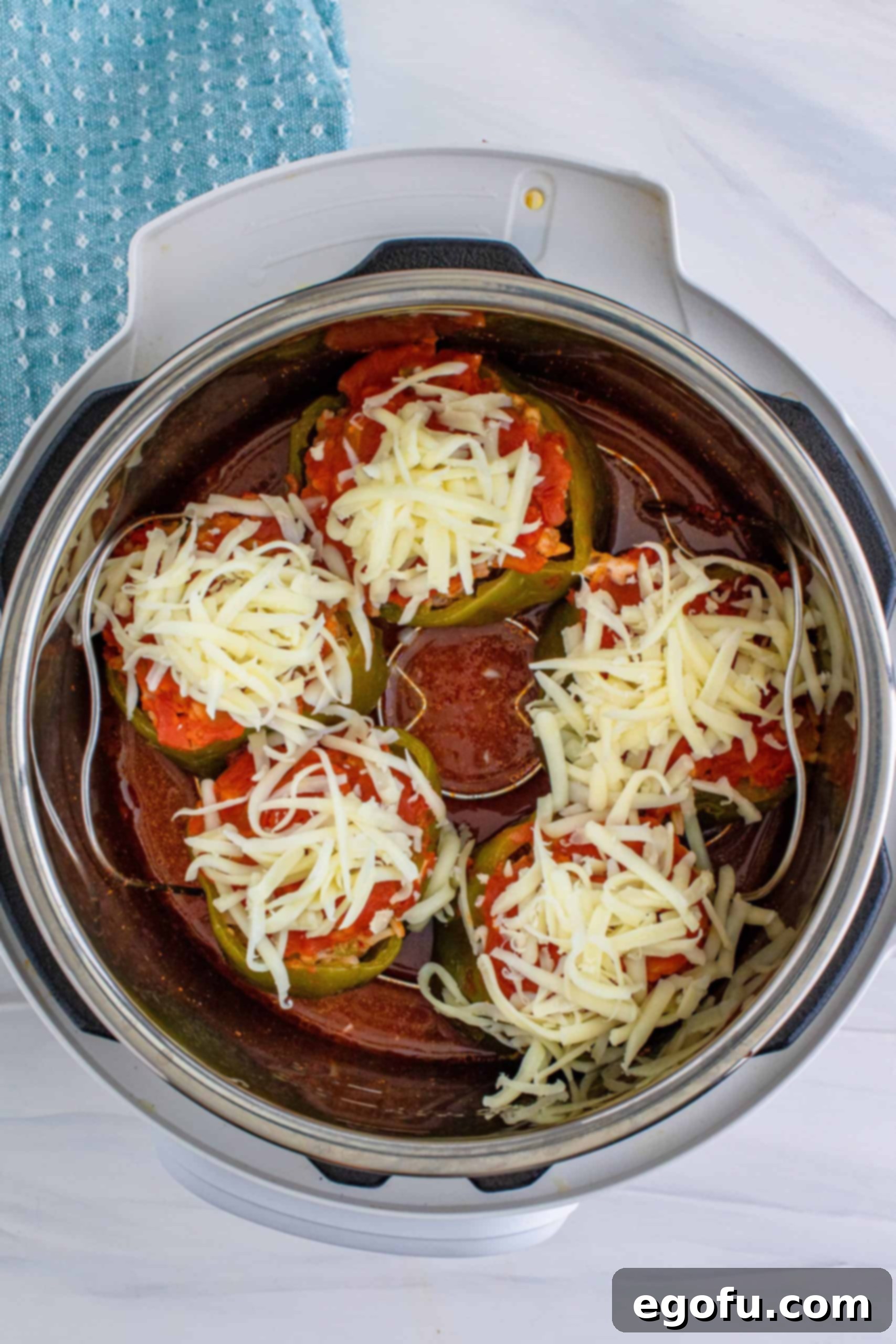 shredded mozzarella on stuffed peppers.