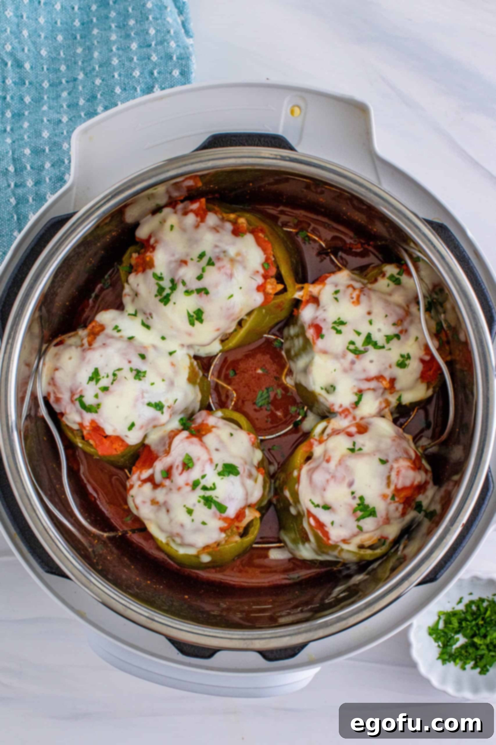 melted cheese on top of stuffed peppers inside instant pot.