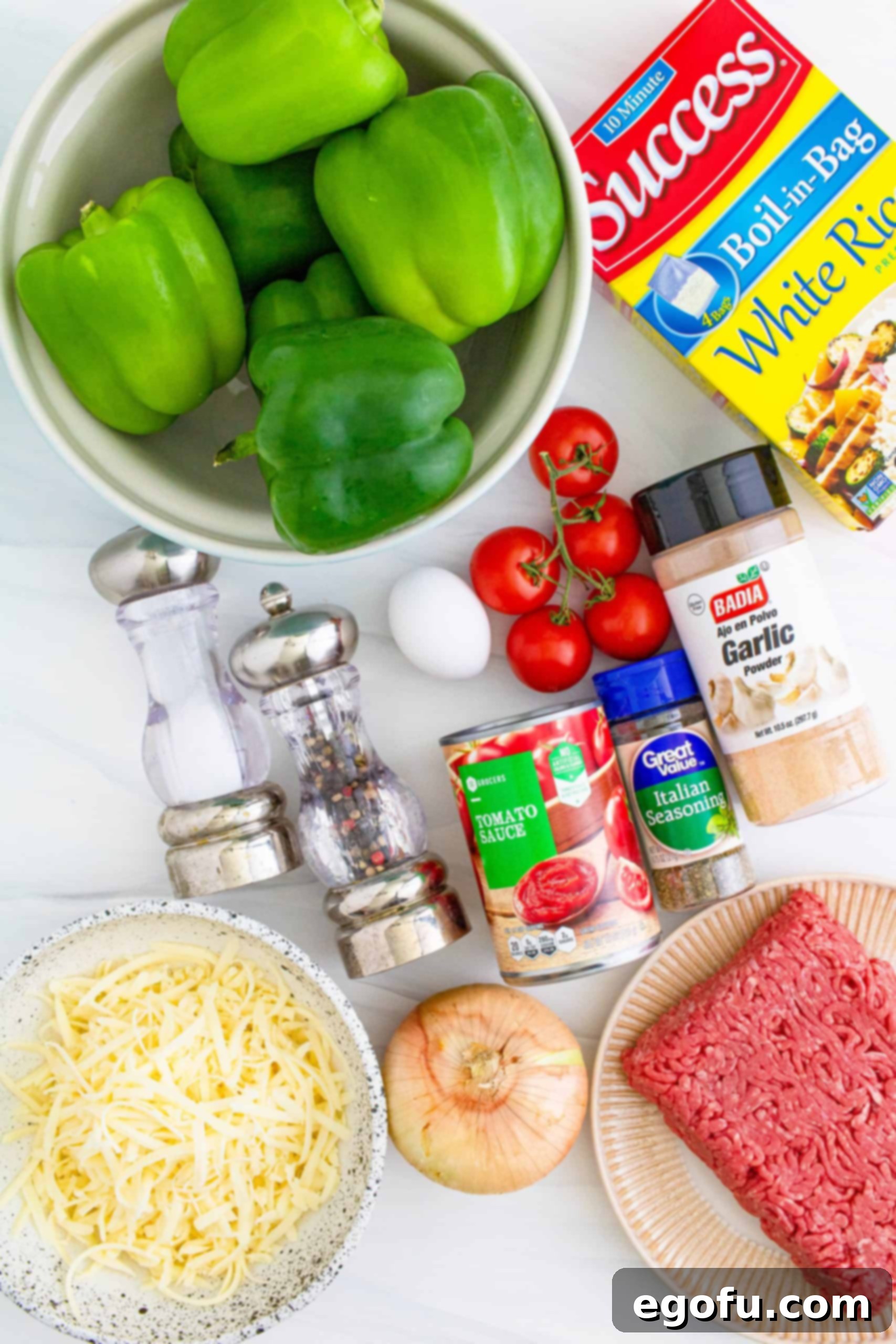Instant Pot Stuffed Peppers ingredients: green bell peppers, onion, tomatoes, extra lean ground beef, boil-in-bag white rice, large egg, salt and pepper, Italian seasoning, garlic powder, tomato sauce, shredded mozzarella cheese