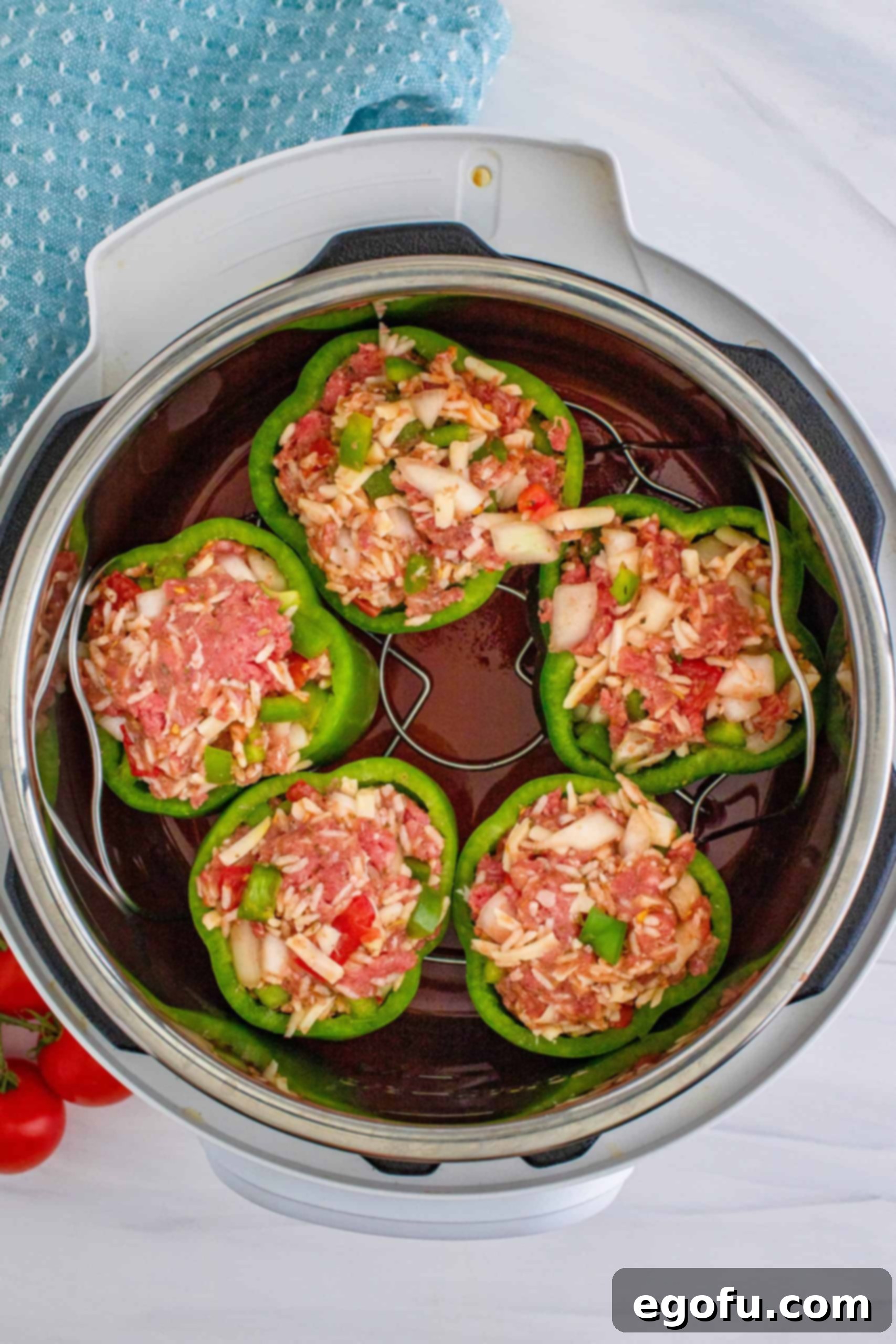 trivet holding 5 stuffed peppers placed inside the instant pot.