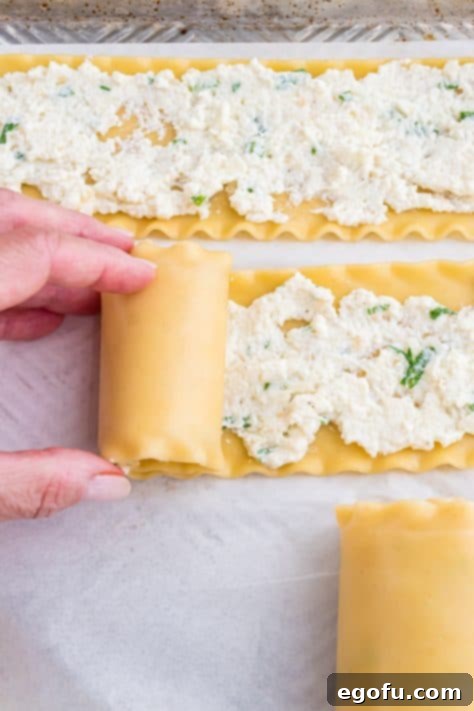 rolling up a lasagna roll up.